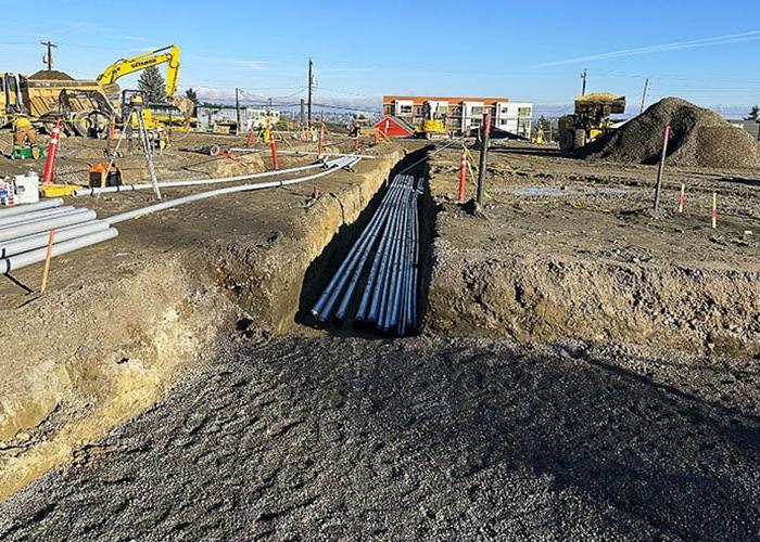 a trench with multiple lines of electrical conduit in it