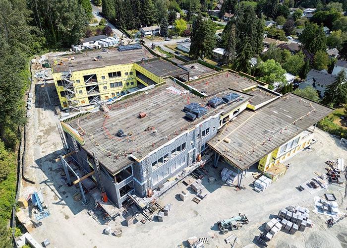 a building under construction with a lot of construction equipment and materials